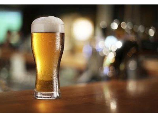 A pint of beer on a bar.