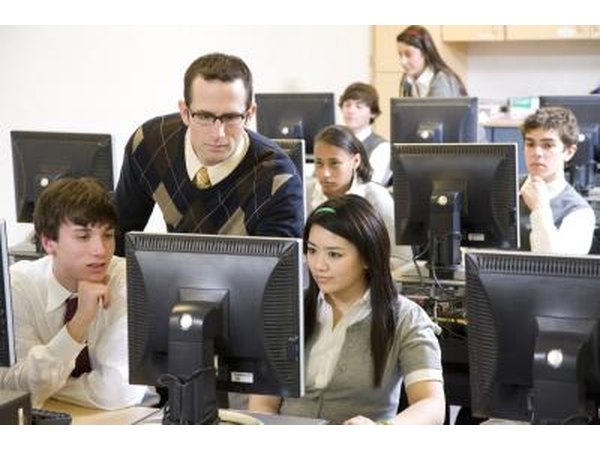 Teacher and students working on computers