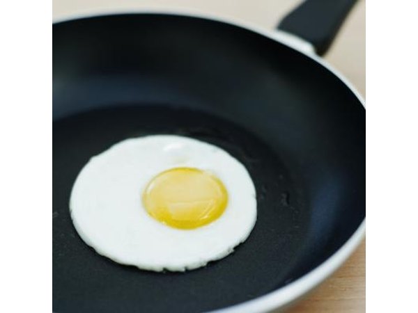 An egg fries in a pan.