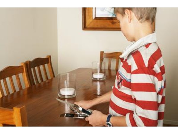 young boy setting table