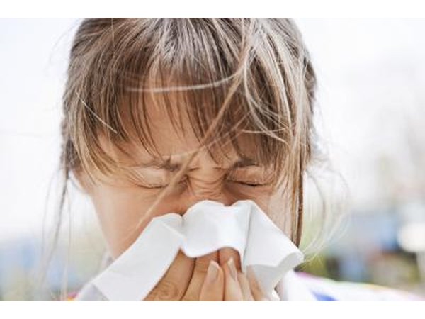 A woman blows her nose outside.