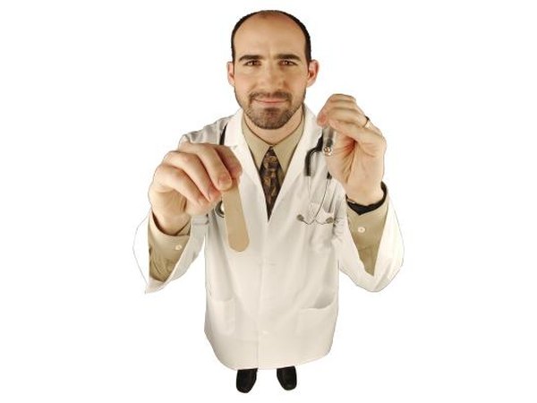 Doctor with tounge depressor and light