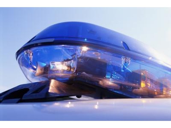 A close-up of an emergency light on top of a police car.
