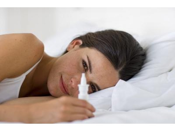 Woman holding nasal spray