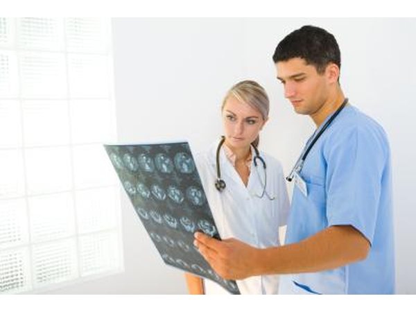 Two doctors examine a patients MRI.