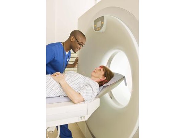 tech and patient at PET scan