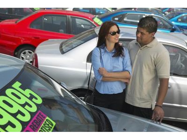 People looking at their new car.