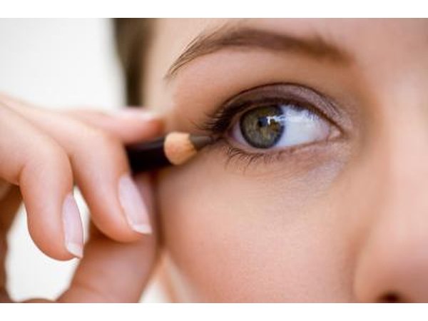 Woman applying eyeliner