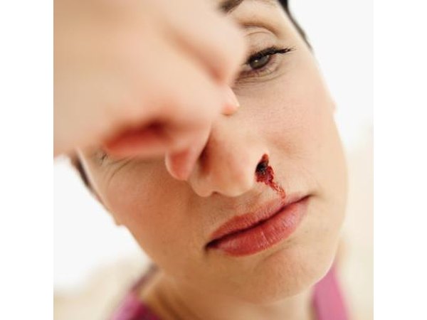 Woman holding nose
