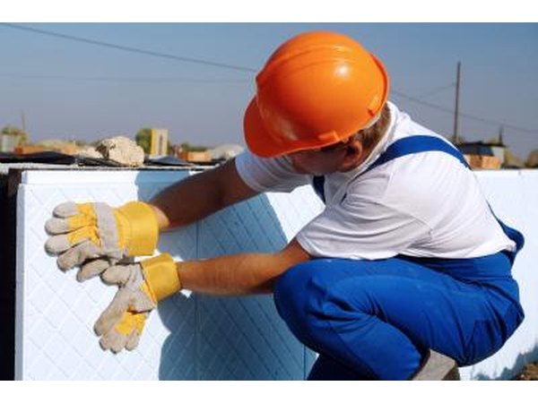 Construction worker using rigid foam insulation