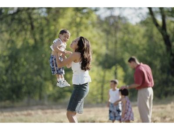 Woman lifting son in air