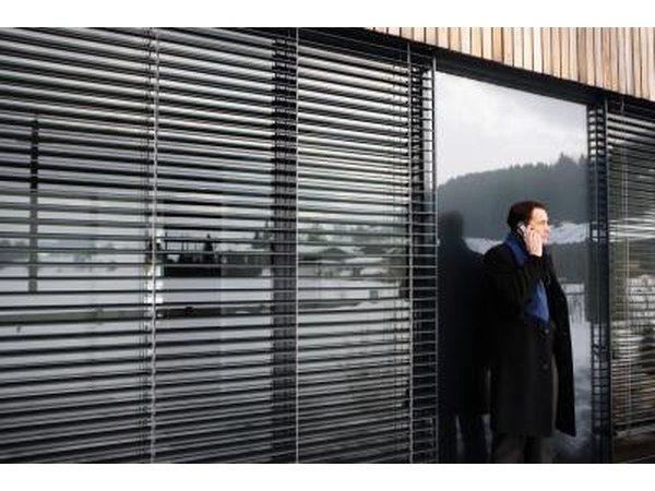 Large blinds on exterior of glass walls.