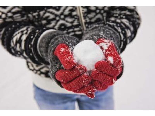 Man holding snow ball in hands