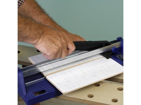 Man cutting a tile.
