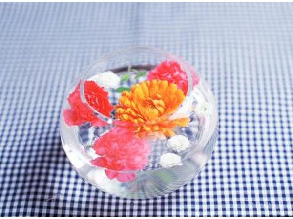 Floating flowers in a bowl is an inexpensive accent to a table.