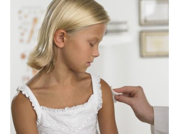 Apply pressure with the cotton ball to stop any bleeding.