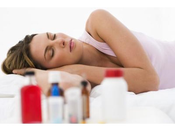 Woman sleeping next to medications