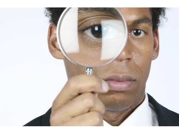 Use a magnifying glass to look for ticks.