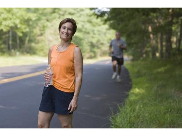 Woman going on exercise walk on side of the road.