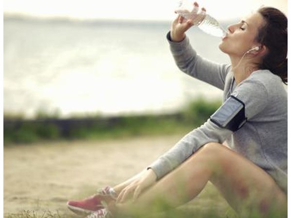 Woman drinks water after exercising