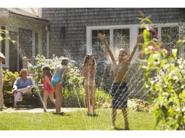 Children running in sprinkler
