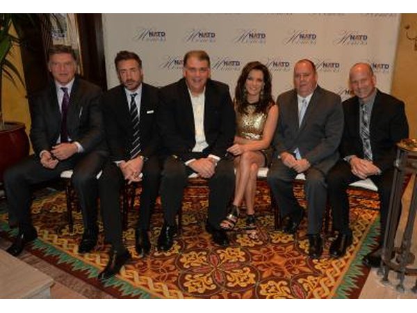 A group of agents, attorneys, and artists pose for a photo at an awards ceremony.