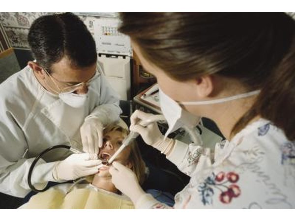 Patient during dental procedure with a drill.