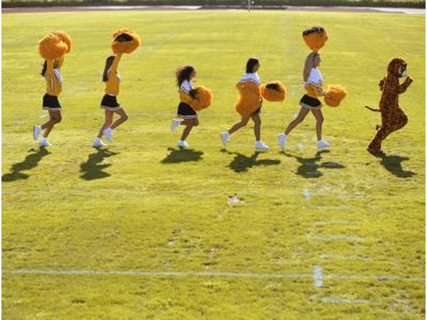 Tiger mascot being followed by cheerleaders