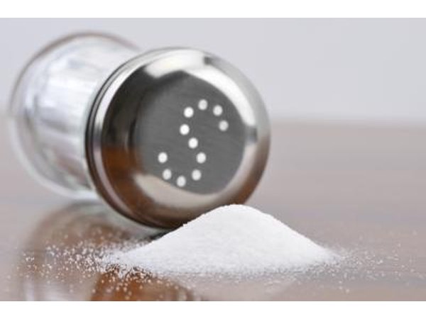 Salt shaker next to spilt salt