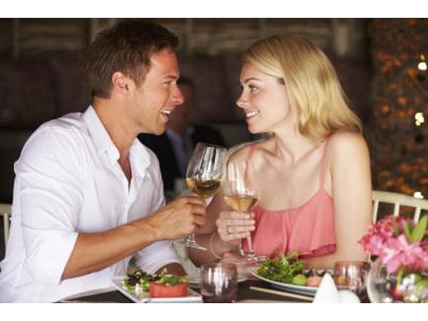 Couple toasting with white wine at restaurant