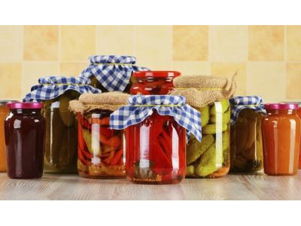 Glass jars filled with vegetables for fermenting.