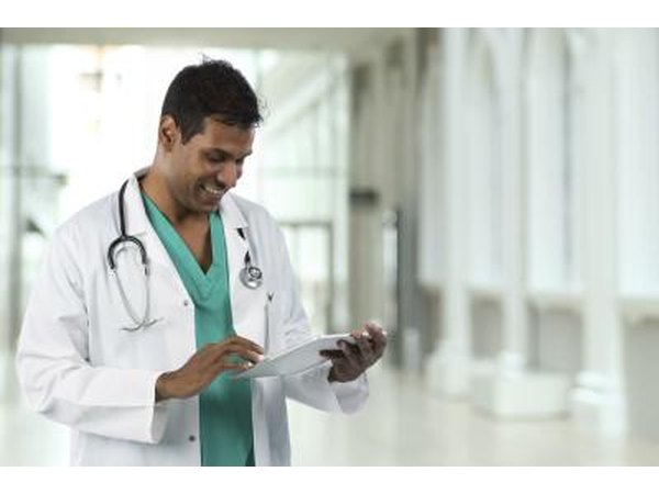 Doctor looks at patient information on tablet