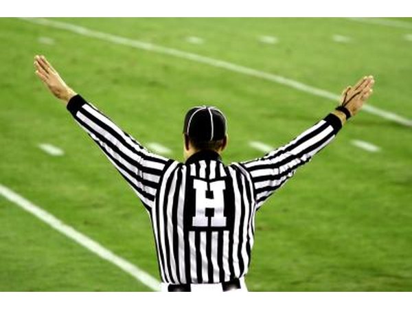 Football official signals on field