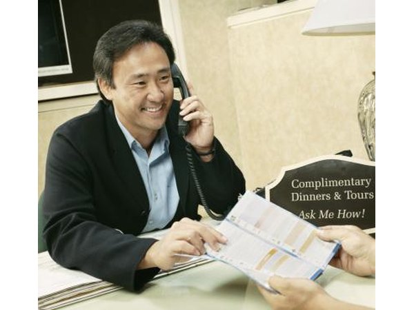 A hotel guest receives assistance at the front desk.