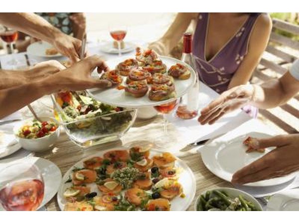People help themselves to assorted appetizers.