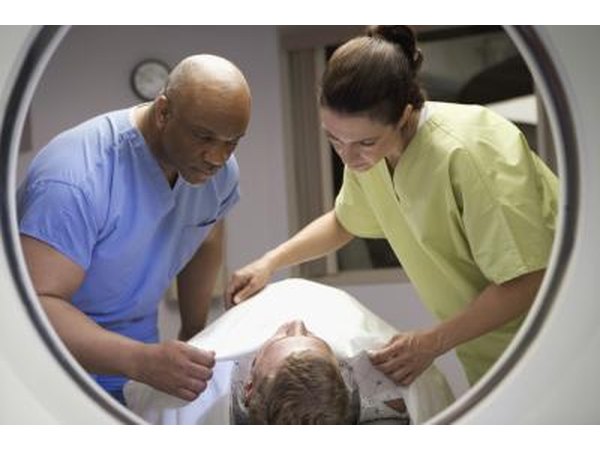 MRI technicians preparing patient