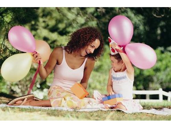 Mother celebrating daughters birthday outdoors