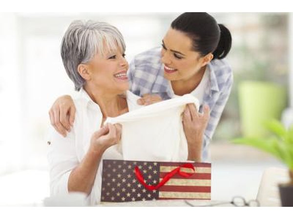 Senior pulling clothes out of gift bag