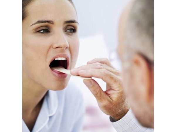 Doctor examining woman's throat