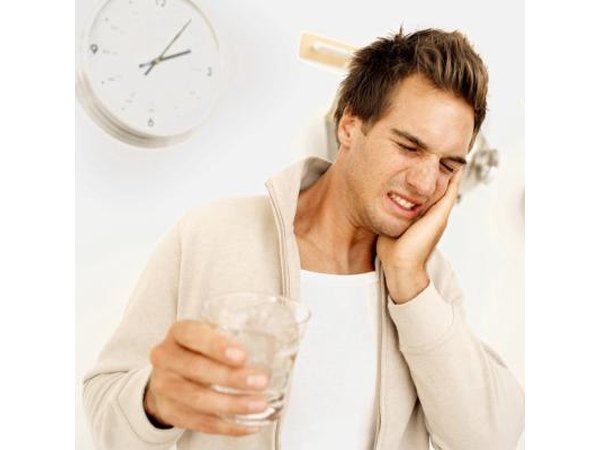 Sharp pain or sensitivity to cold drinks could be caused by receding gums or a cavity