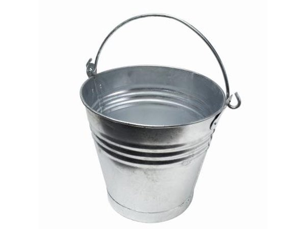 Skip the overused paper goody bags and use a silver pail filled with green cellophane grass.
