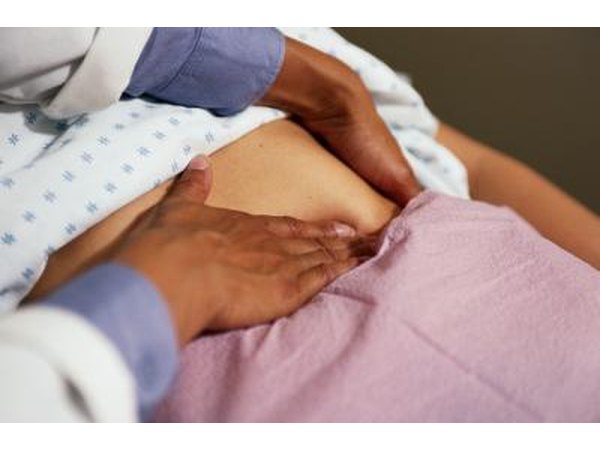 Doctor examining abdomen of patient