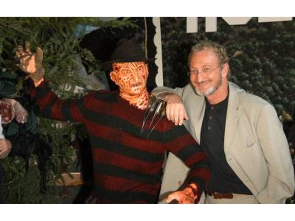 Man posing with Freddy Krueger costume