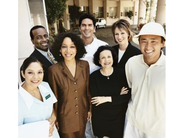 Portrait of a hotel staff standing in front of the hotel.