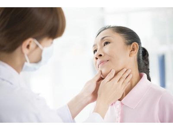 A doctor checking a patient's thyroid gland.