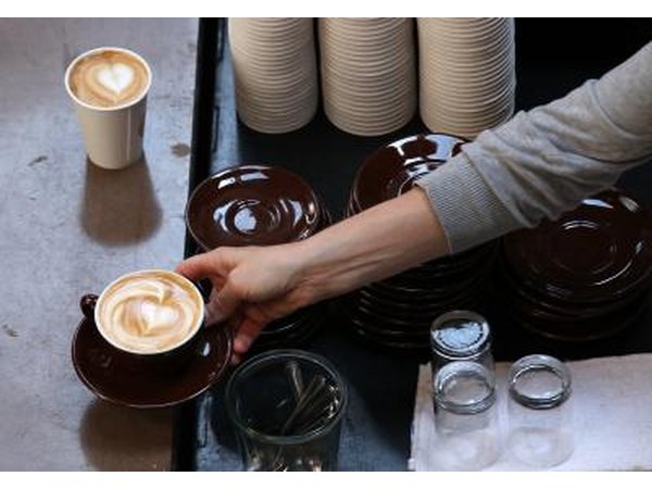 Barista serving drink with "latte art" to customer