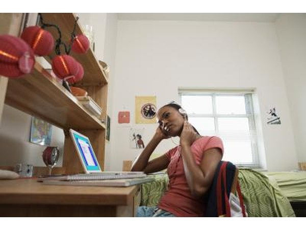 Girl with laptop in dorm room.