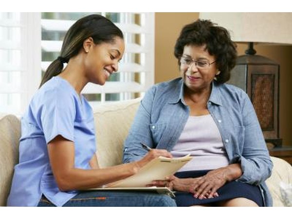 Health care worker talks to woman