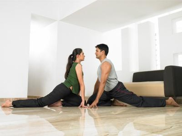 Man and woman doing One-Legged Pigeon pose.