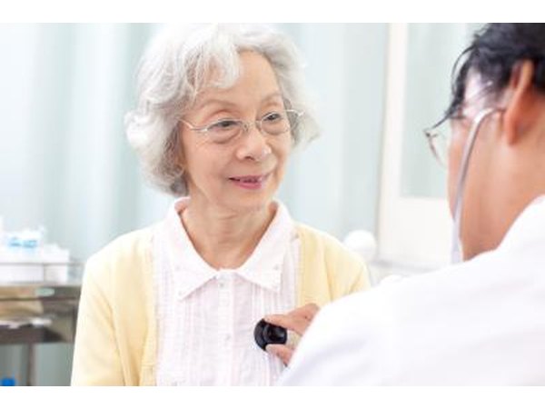 Doctor listening to senior woman's chesta